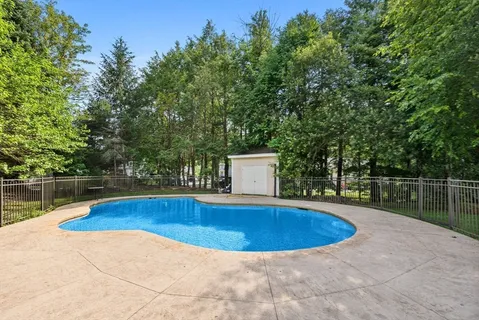 a view of outdoor space with swimming pool and seating