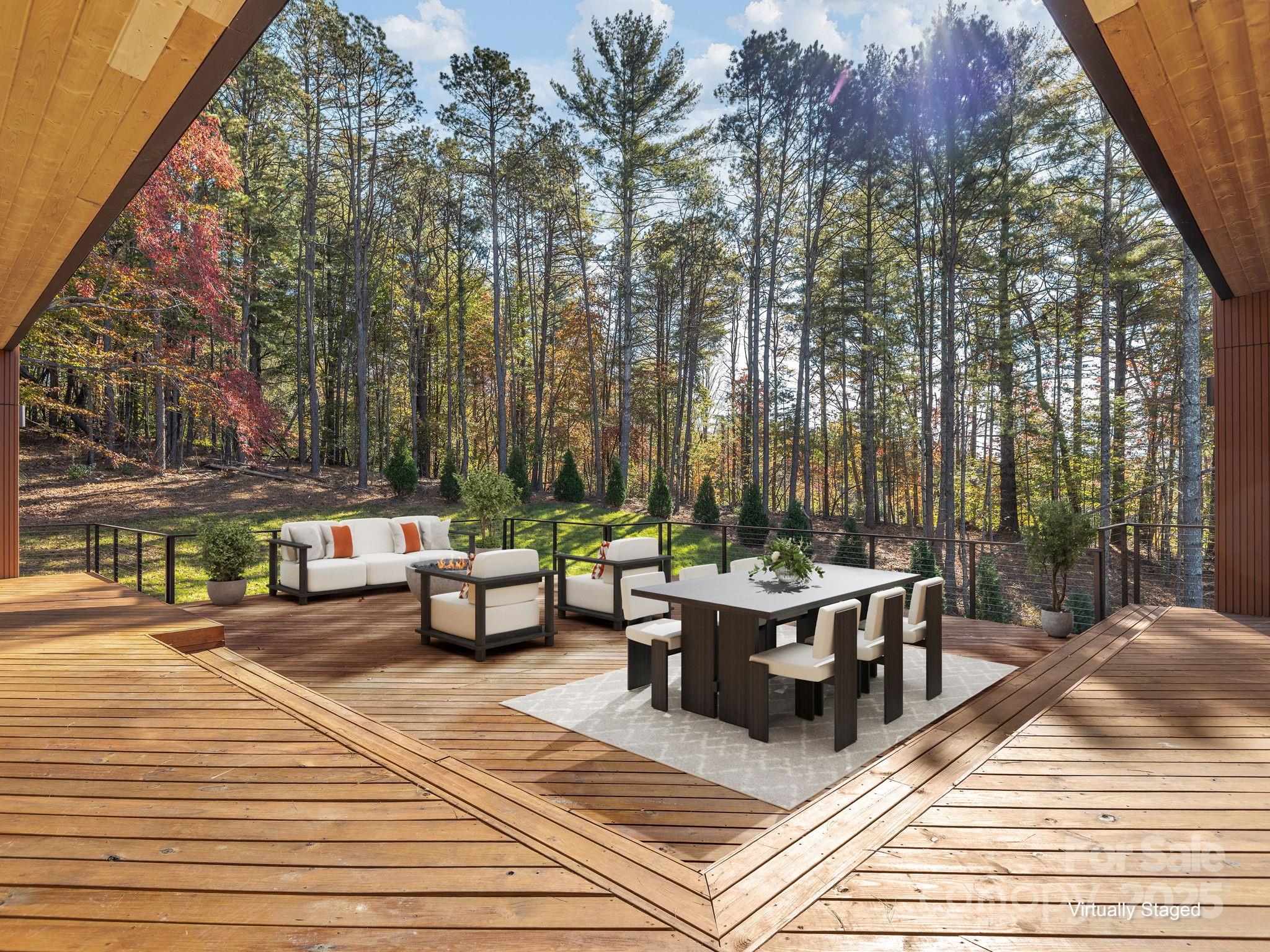 87 Verbania Rd Mills River Mills River, NC 28759 - Photo 22 of 27 a view of a patio with dining table and chairs with wooden floor and fence
