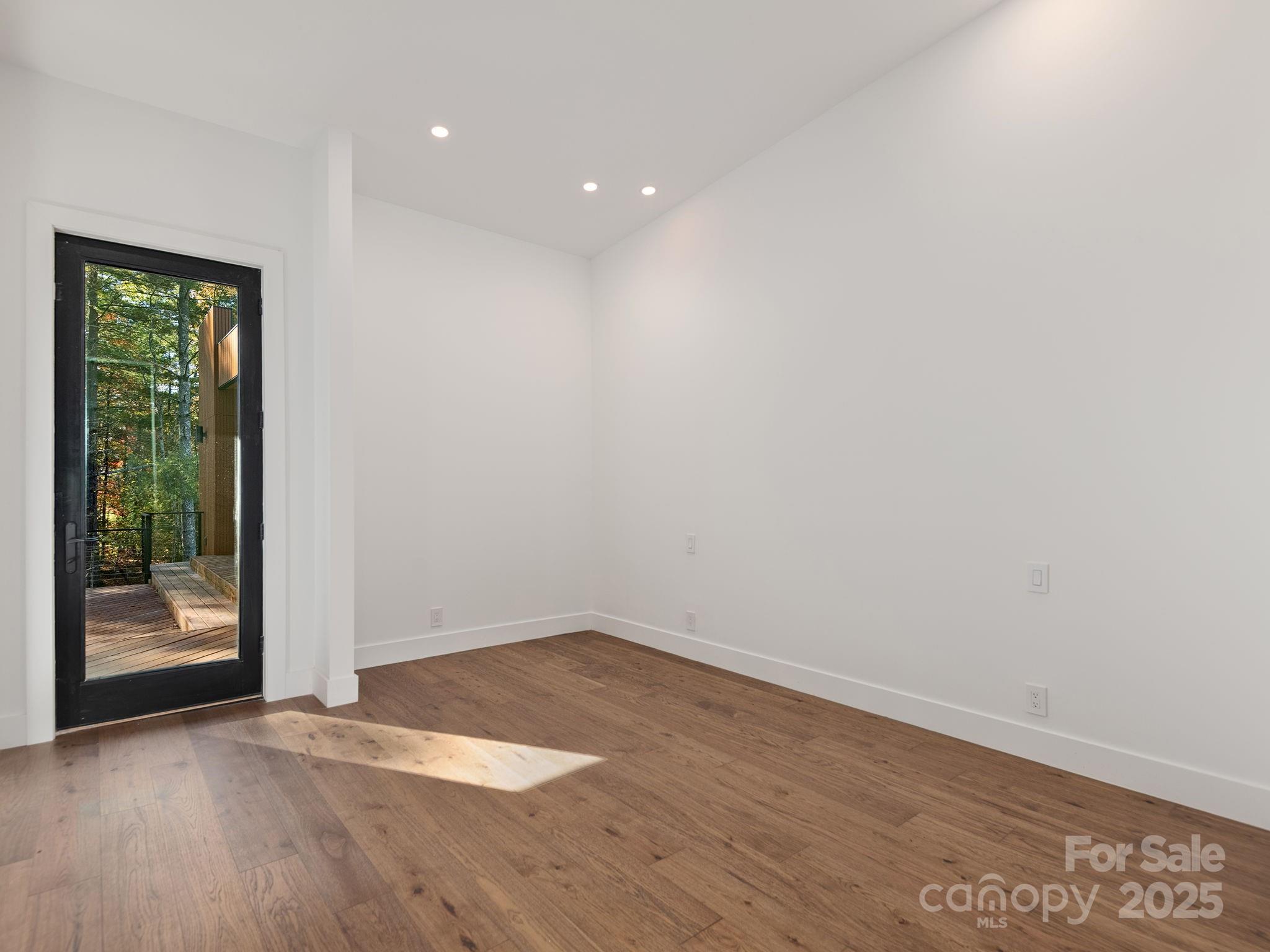 87 Verbania Rd Mills River Mills River, NC 28759 - Photo 10 of 27 a view of an empty room with wooden floor and a window