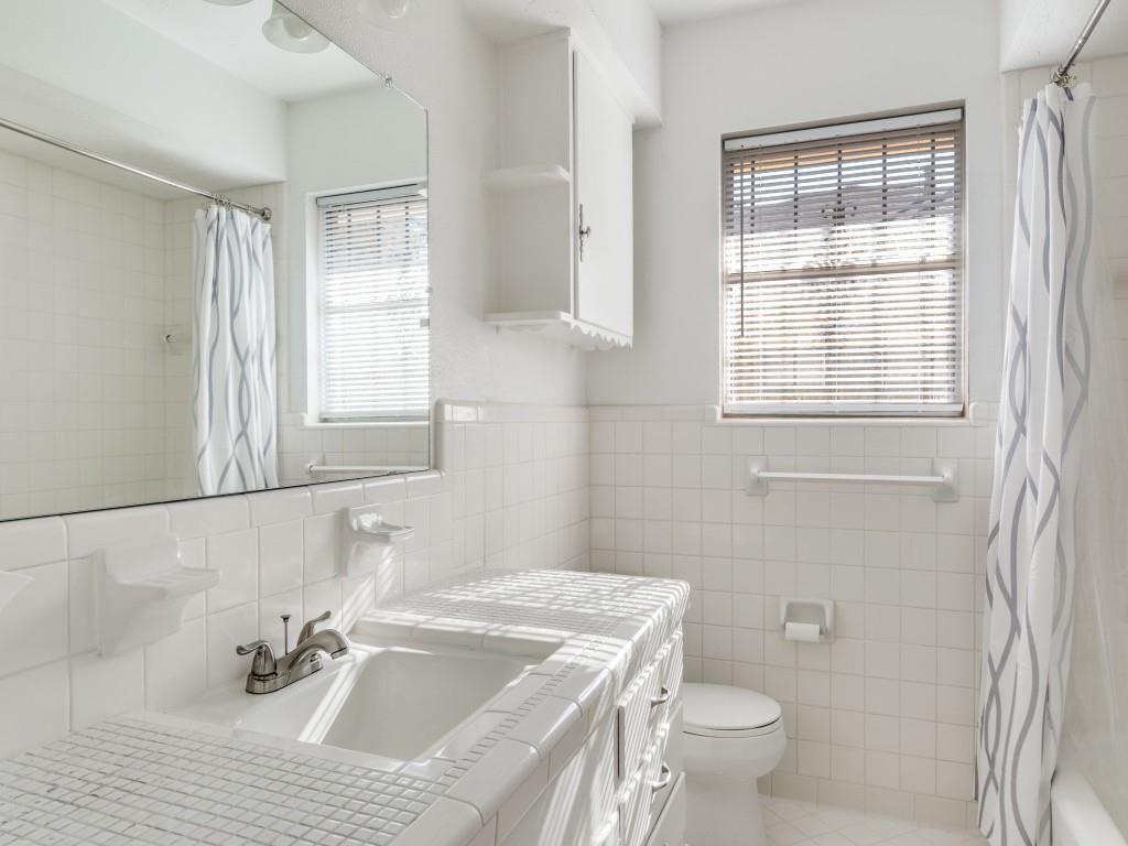 7415-7417 Walling Lane Dallas, TX 75231 - Photo 11 of 25 a bathroom with a sink toilet and window