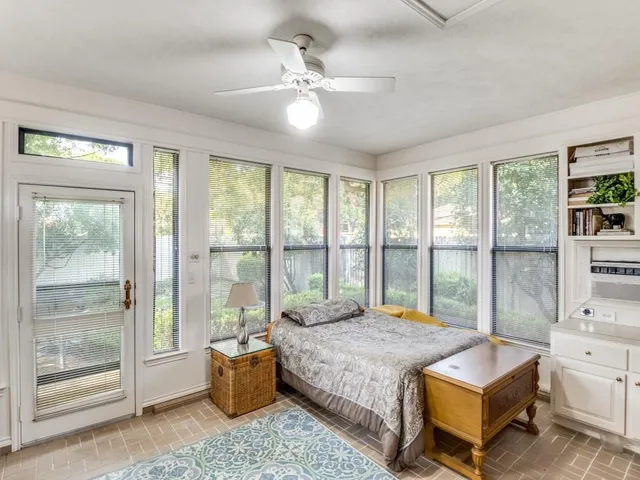 a living room with furniture and large windows