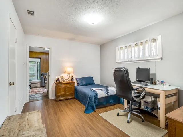 a bedroom with furniture and a window