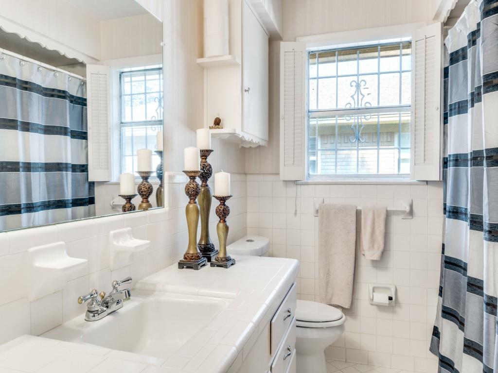 7415-7417 Walling Lane Dallas, TX 75231 - Photo 20 of 25 a bathroom with a sink and a toilet
