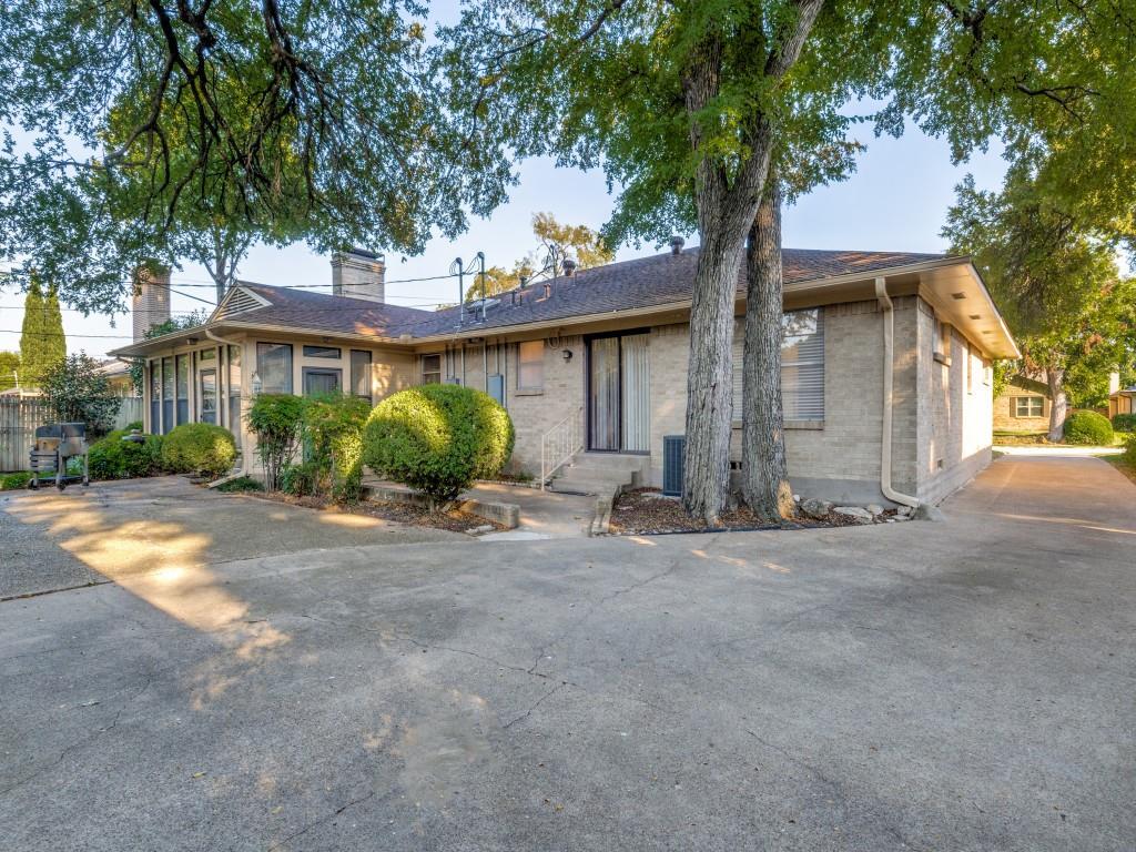 7415-7417 Walling Lane Dallas, TX 75231 - Photo 22 of 25 a view of a house with a tree and a yard