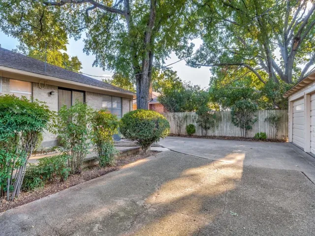a view of a house with a tree in the background