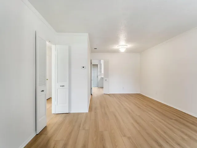 a view of an empty room and wooden floor