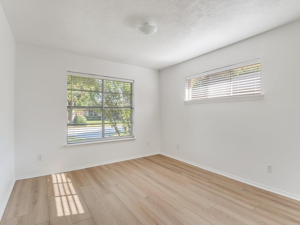 7415-7417 Walling Lane Dallas, TX 75231 - Photo 10 of 25 an empty room with wooden floor and windows