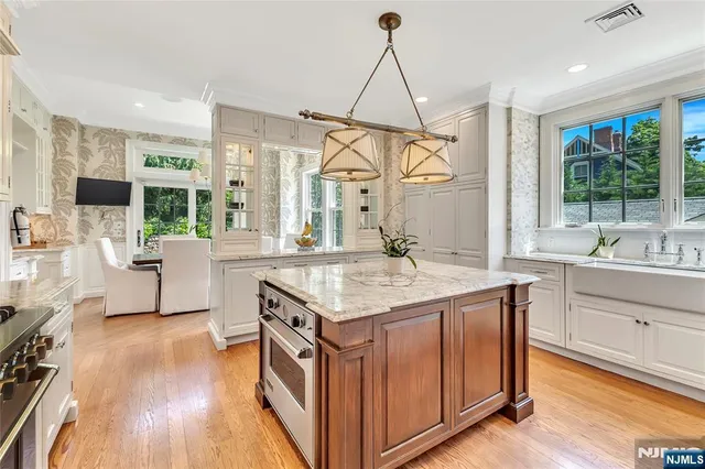 a kitchen with stainless steel appliances granite countertop a sink and a wooden floors