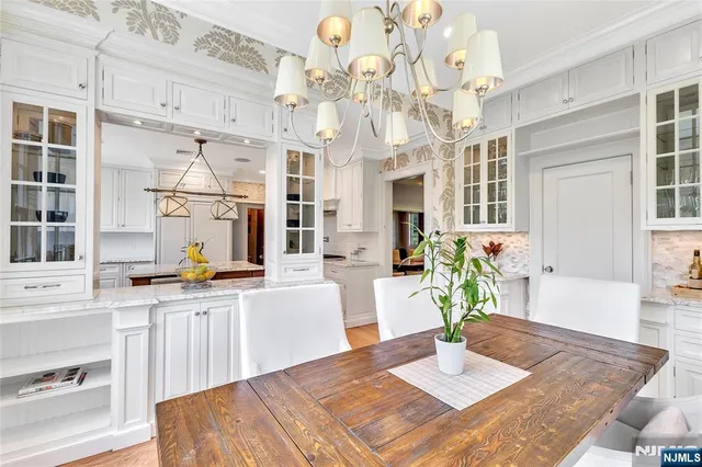 a living room with fireplace furniture and a chandelier