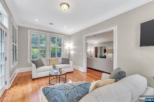 a living room with a fireplace and a large window