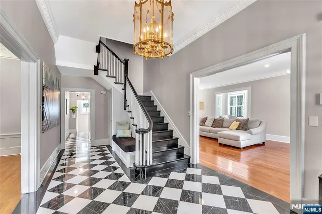 a living room with furniture and a chandelier
