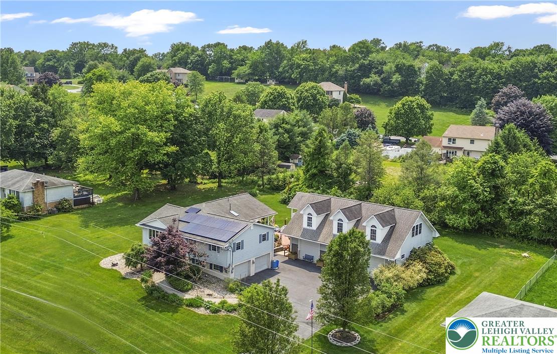 an aerial view of a house with garden space and street view
