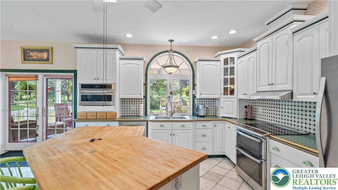 807 Bangor Road Nazareth, PA 18064 - Photo 22 of 46 a kitchen with stainless steel appliances granite countertop a stove a sink and a white cabinets