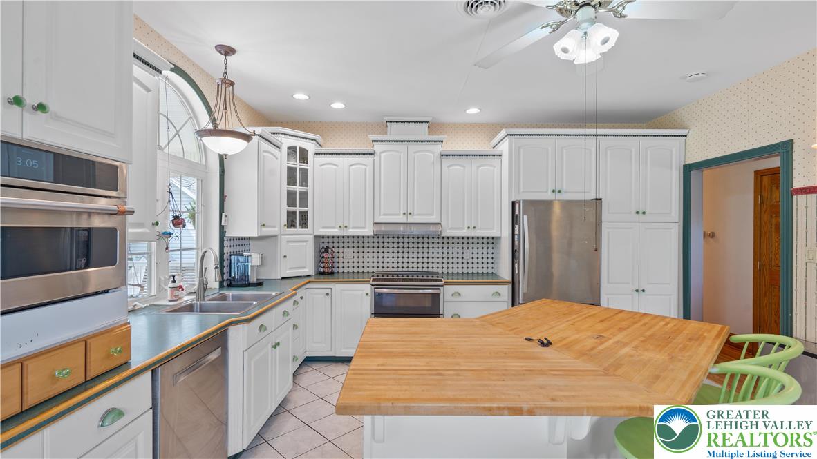 807 Bangor Road Nazareth, PA 18064 - Photo 24 of 46 a kitchen with stainless steel appliances kitchen island granite countertop a refrigerator and a sink