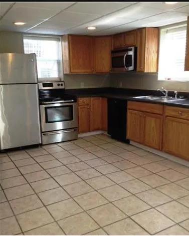 a kitchen with stainless steel appliances a refrigerator and a stove top oven
