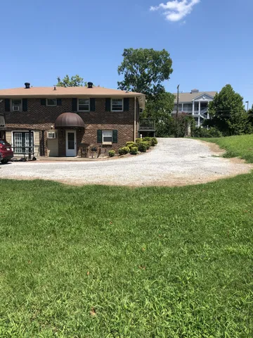 a view of a house with a backyard porch and sitting area