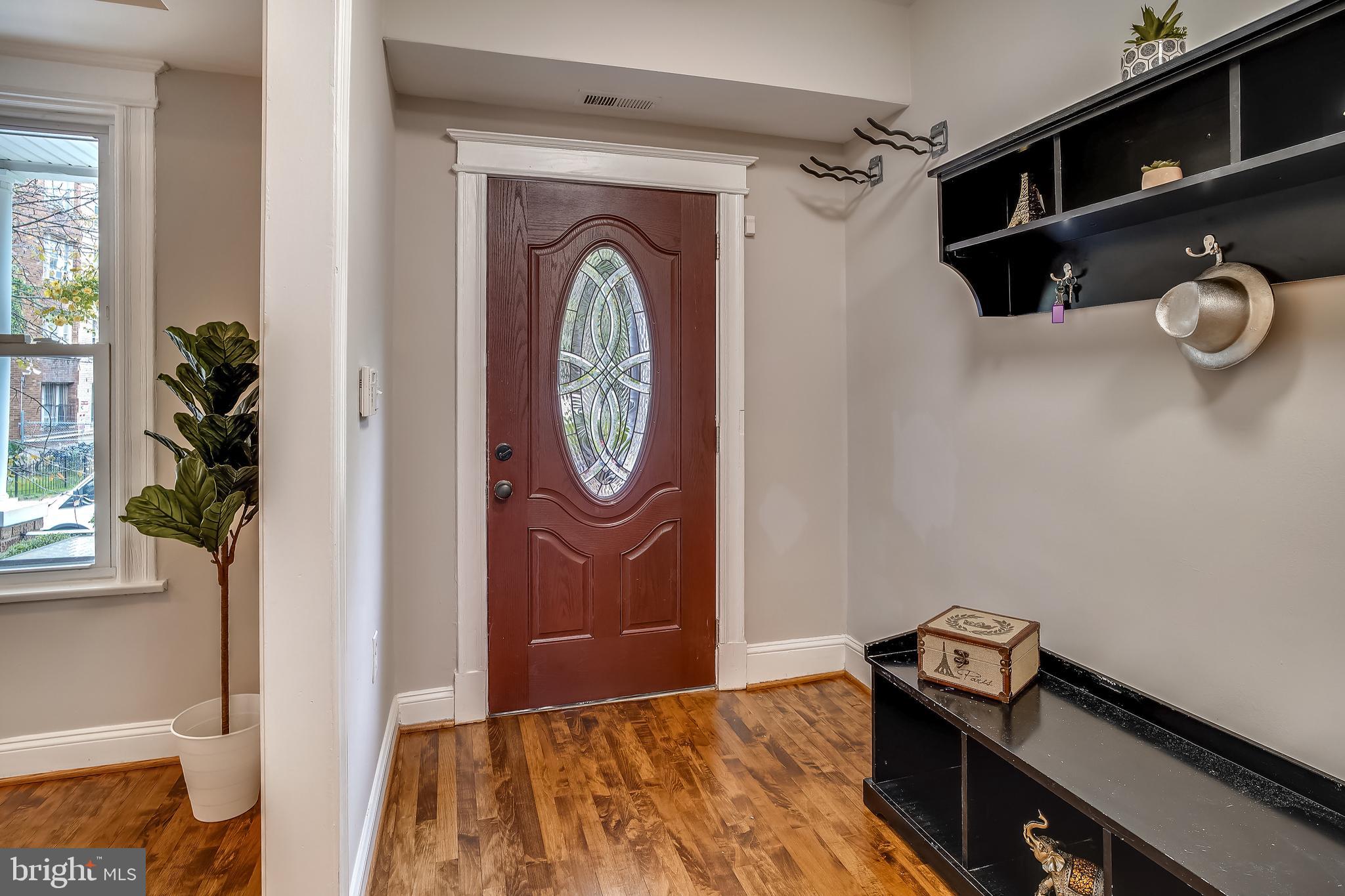 1462 Spring Road Northwest Washington, DC 20010 - Photo 5 of 61 Foyer with Custom Door and Hardwood Floors