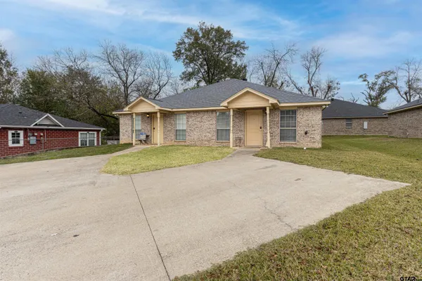 front view of a house with a yard