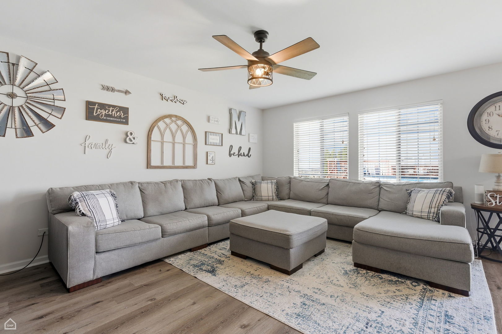 617 Brita Trail Minooka, IL 60447 - Photo 12 of 34 a living room with furniture a ceiling fan and a large window