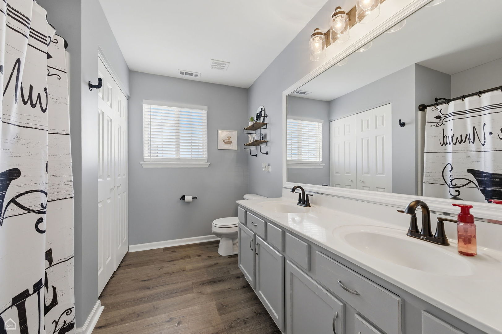 617 Brita Trail Minooka, IL 60447 - Photo 17 of 34 a bathroom with a double vanity sink a mirror and a shower