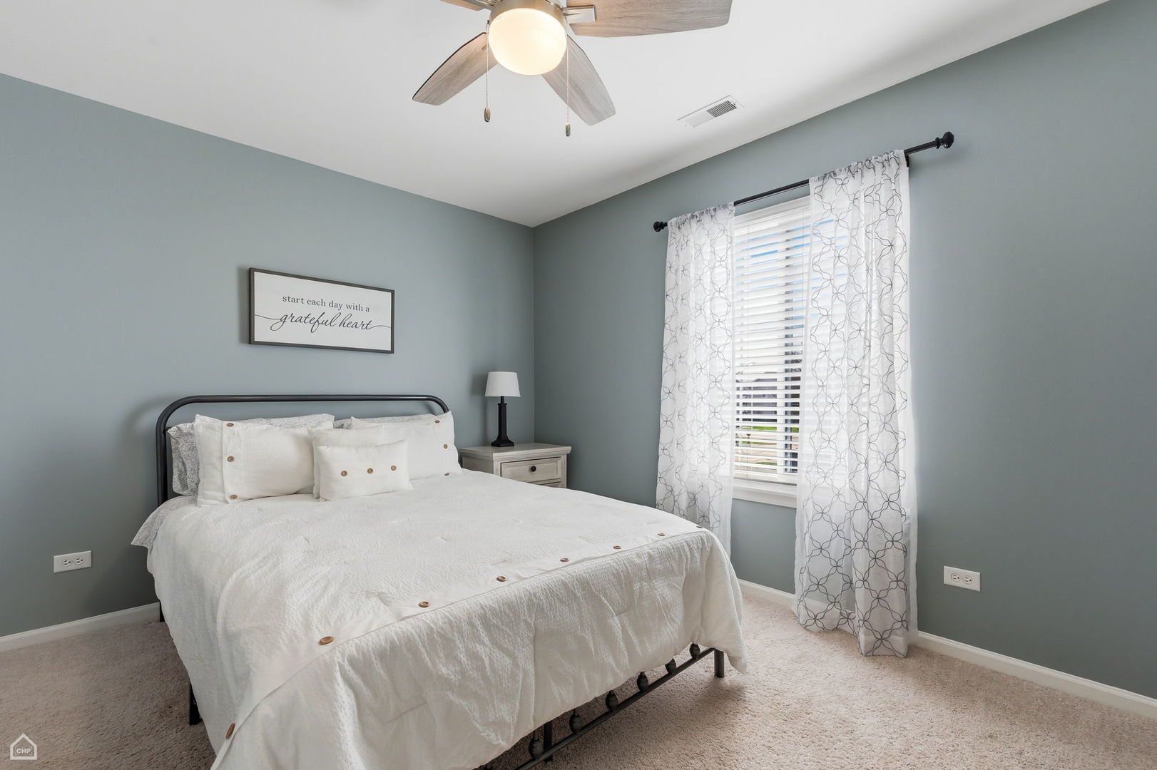 617 Brita Trail Minooka, IL 60447 - Photo 20 of 34 a bedroom with a large bed and a chandelier