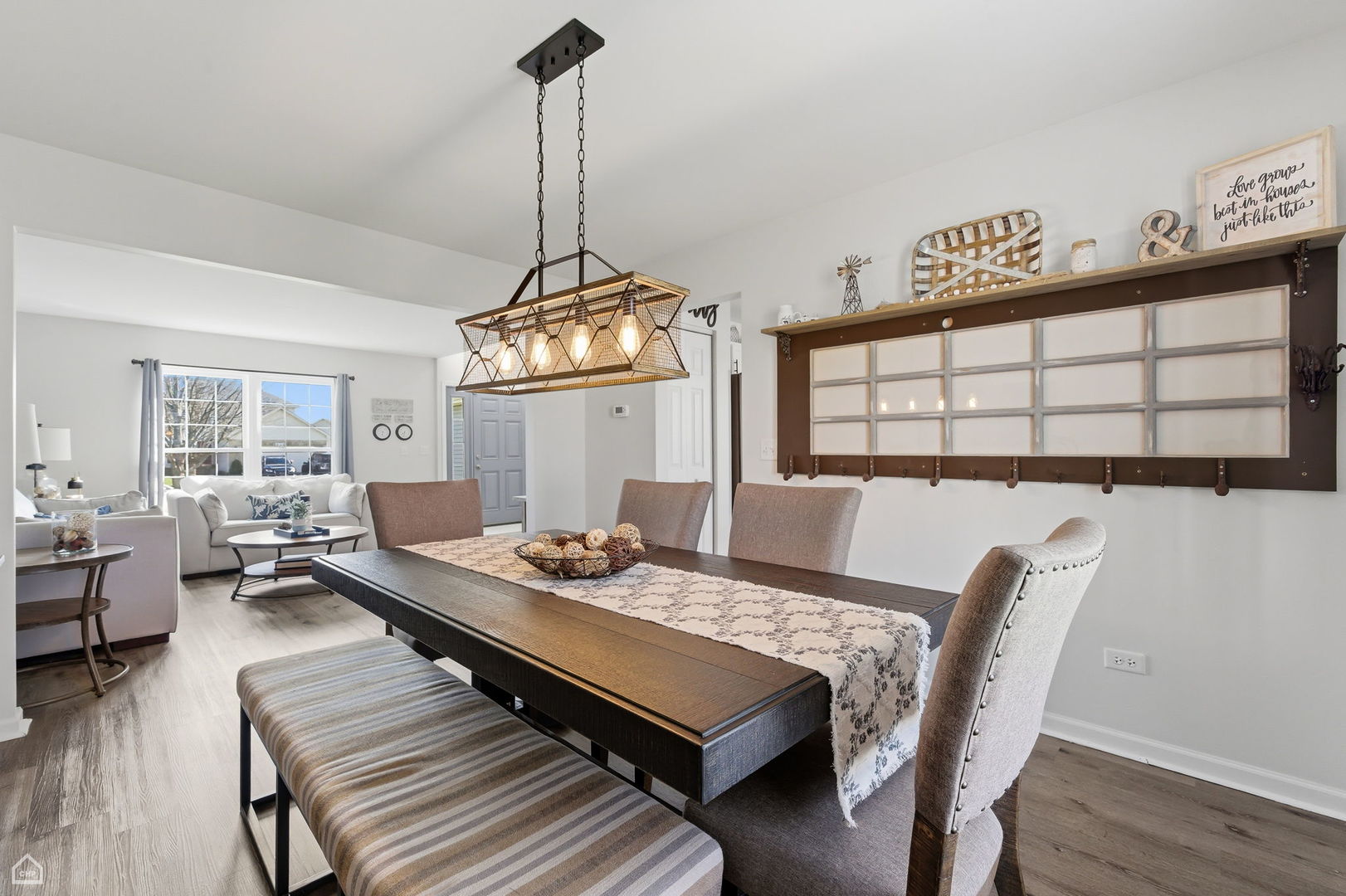 617 Brita Trail Minooka, IL 60447 - Photo 7 of 34 a view of a dining room with furniture window and wooden floor