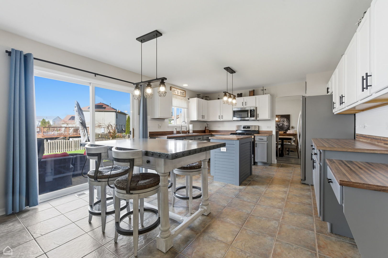 617 Brita Trail Minooka, IL 60447 - Photo 10 of 34 a kitchen with stainless steel appliances a table and chairs in it