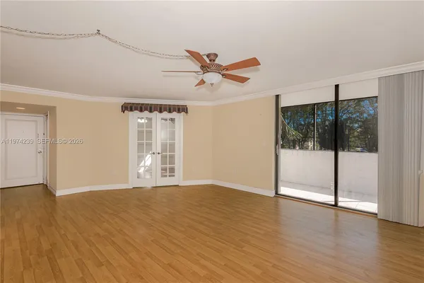 a view of an empty room with glass door