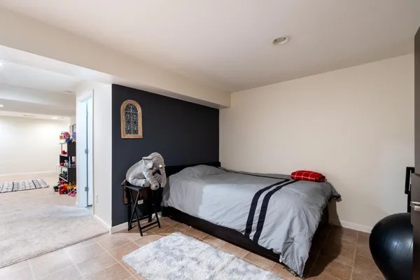 a bedroom with a bed and a chair