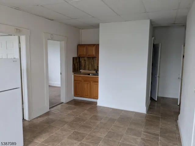 a view of kitchen and refrigerator