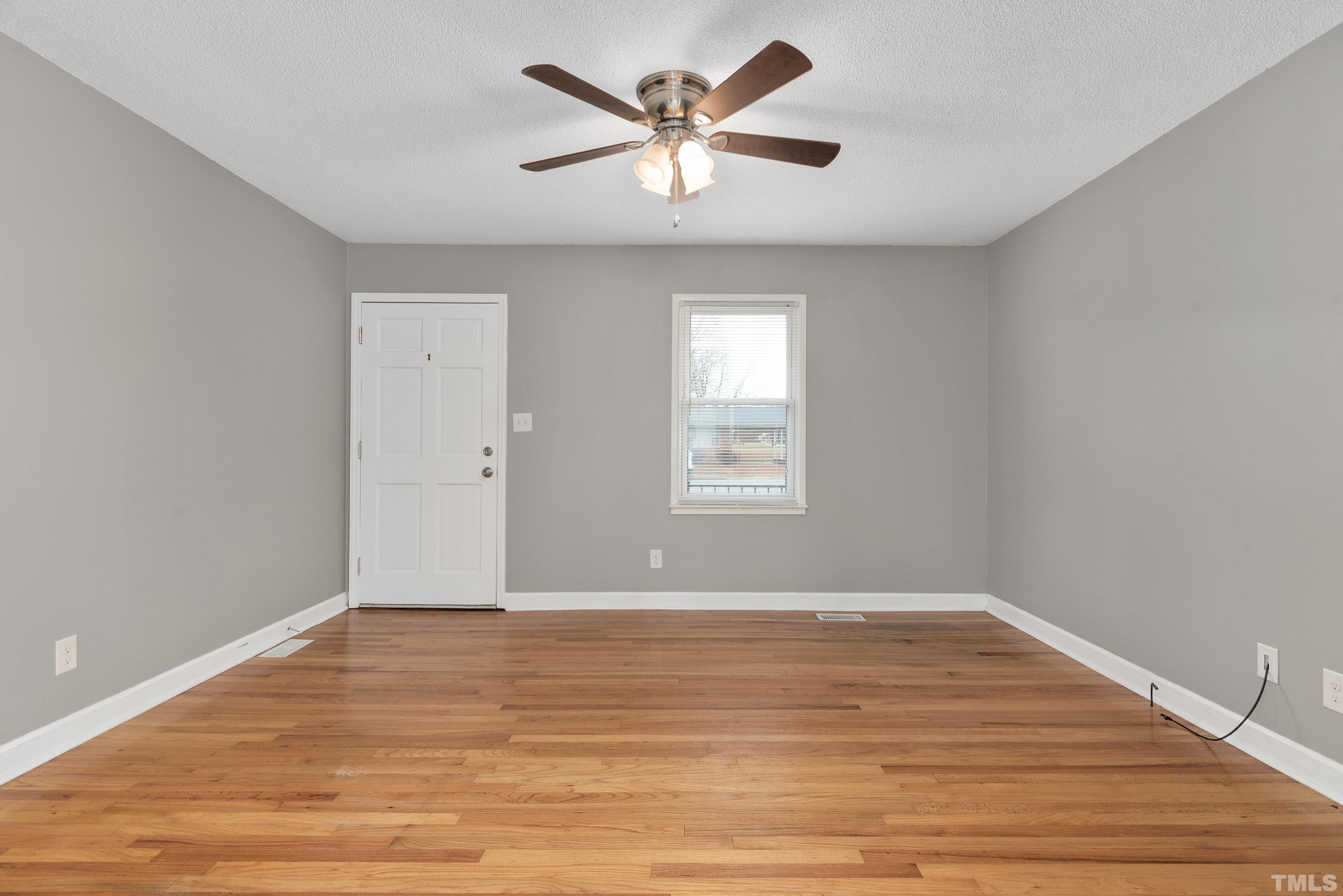 201 West B Street Erwin, NC 28339 - Photo 11 of 25 wooden floor in an empty room with a window