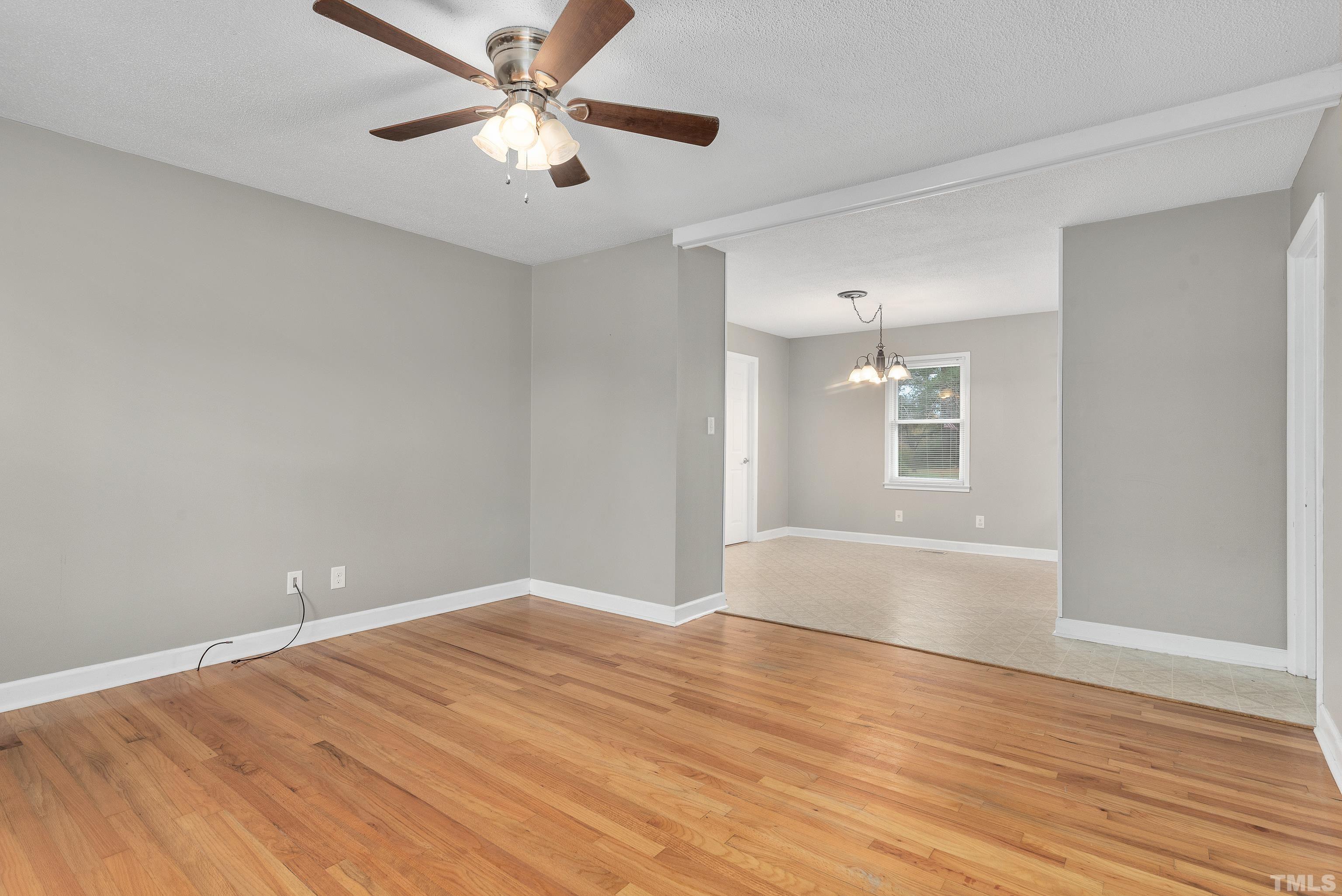 201 West B Street Erwin, NC 28339 - Photo 13 of 25 a view of a room with wooden floor and a ceiling fan