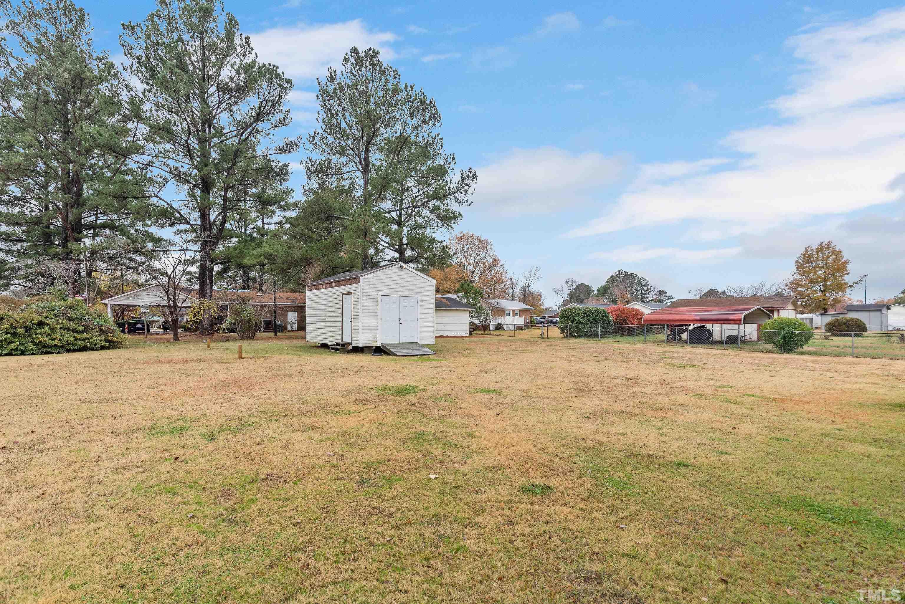 201 West B Street Erwin, NC 28339 - Photo 4 of 25 a backyard of a house with lots of green space
