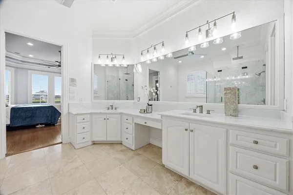 a spacious bathroom with a double vanity sink mirror and bathtub