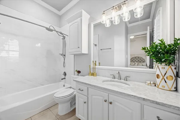 a bathroom with a granite countertop sink a toilet and bathtub