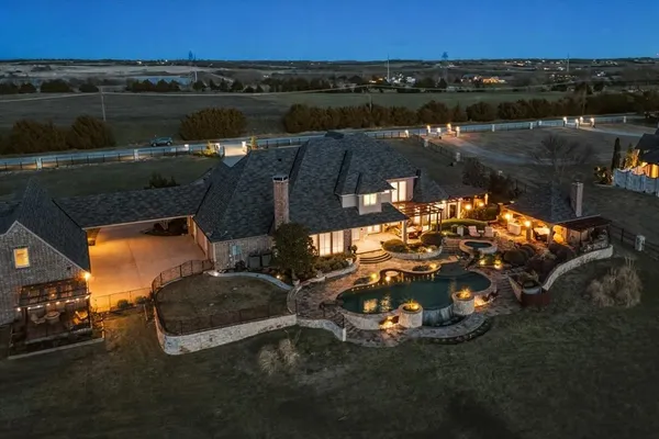 an aerial view of a house with a yard lake view and mountain view