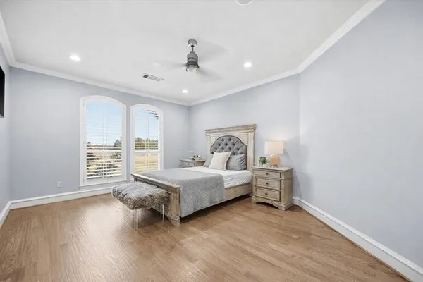 a spacious bedroom with a bed and a window