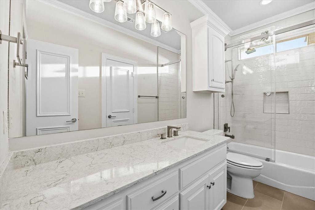 1572 Rabbit Rdg Road Heath, TX 75032 - Photo 24 of 40 a bathroom with a granite countertop sink a toilet and shower