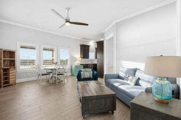 a living room with furniture flat screen tv and couches