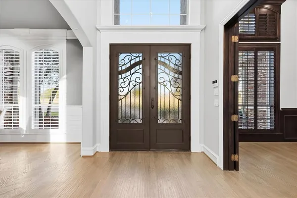 an entryway view with wooden floor and windows