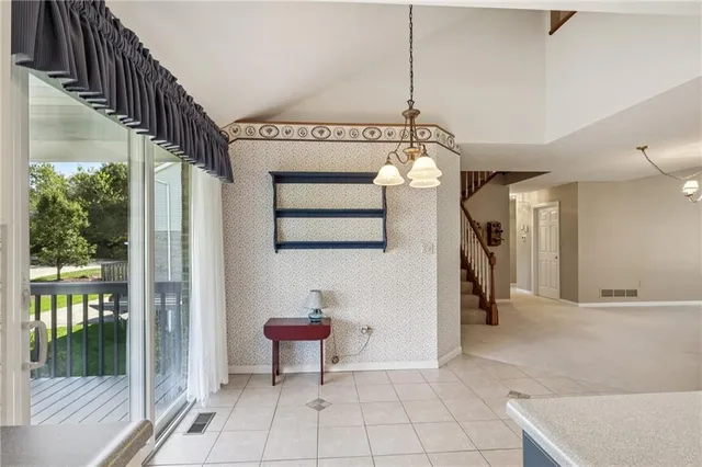 a view of an entryway with wooden floor and a chandelier