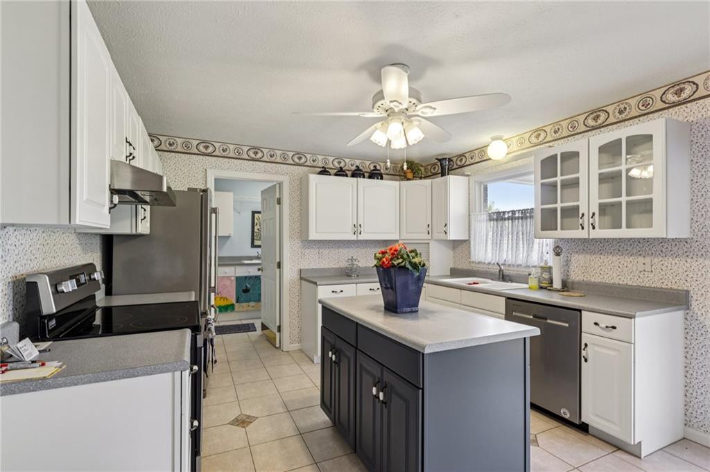 306 Country View Drive Lower Burrell, PA 15068 - Photo 14 of 50 a kitchen with stainless steel appliances granite countertop a sink stove and refrigerator