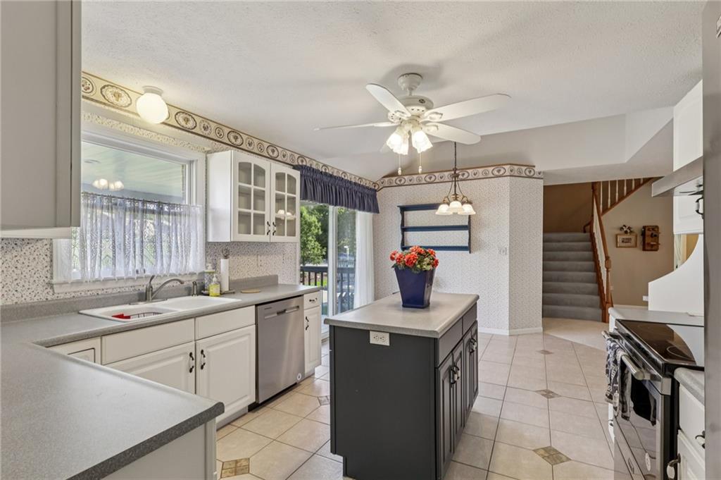 306 Country View Drive Lower Burrell, PA 15068 - Photo 15 of 50 a kitchen that has a lot of cabinets in it and a sink