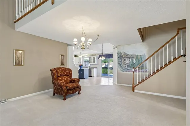 a living room with furniture and a chandelier