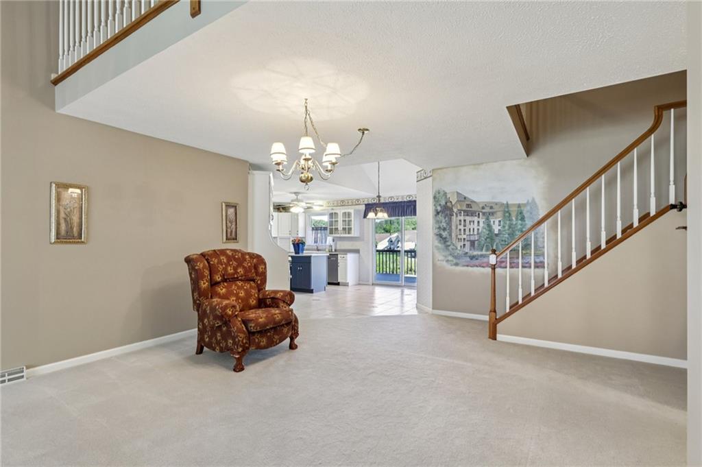 306 Country View Drive Lower Burrell, PA 15068 - Photo 7 of 50 a living room with furniture and a chandelier