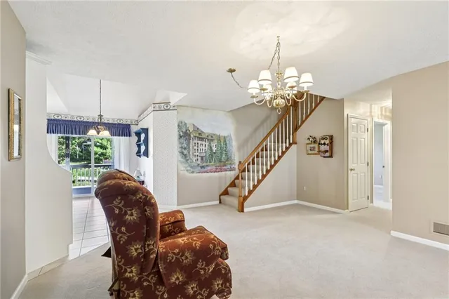 a living room with furniture and a chandelier