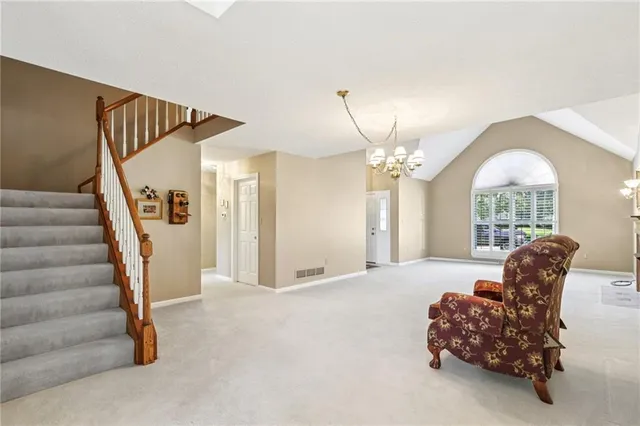 a bedroom with furniture and a large window