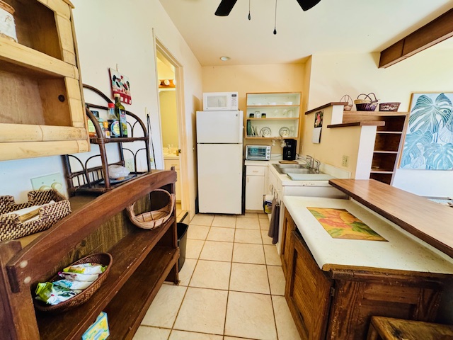 78-6745 Walua Road Kailua-Kona, HI 96740 - Photo 17 of 23 a kitchen with stainless steel appliances granite countertop a stove and a refrigerator
