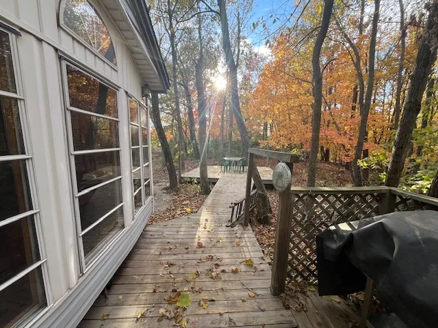 a view of a wooden dinning table with chairs in the patio