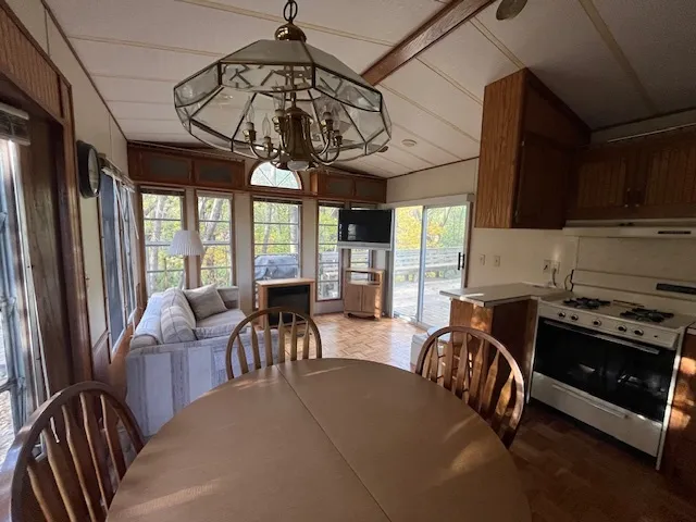 a view of a dining room with furniture window and outside view